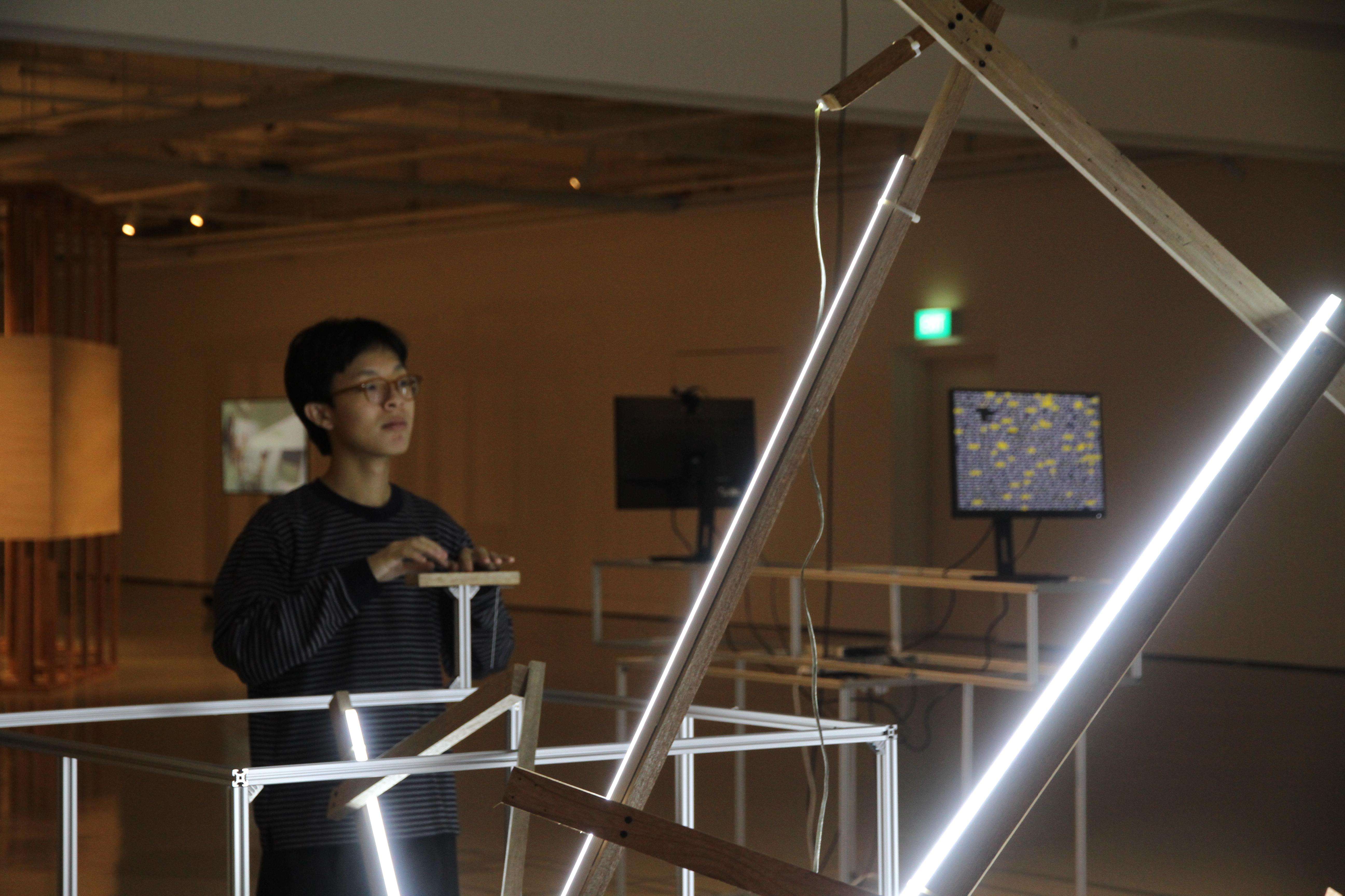 Visitors engaging with The Heart light sculpture