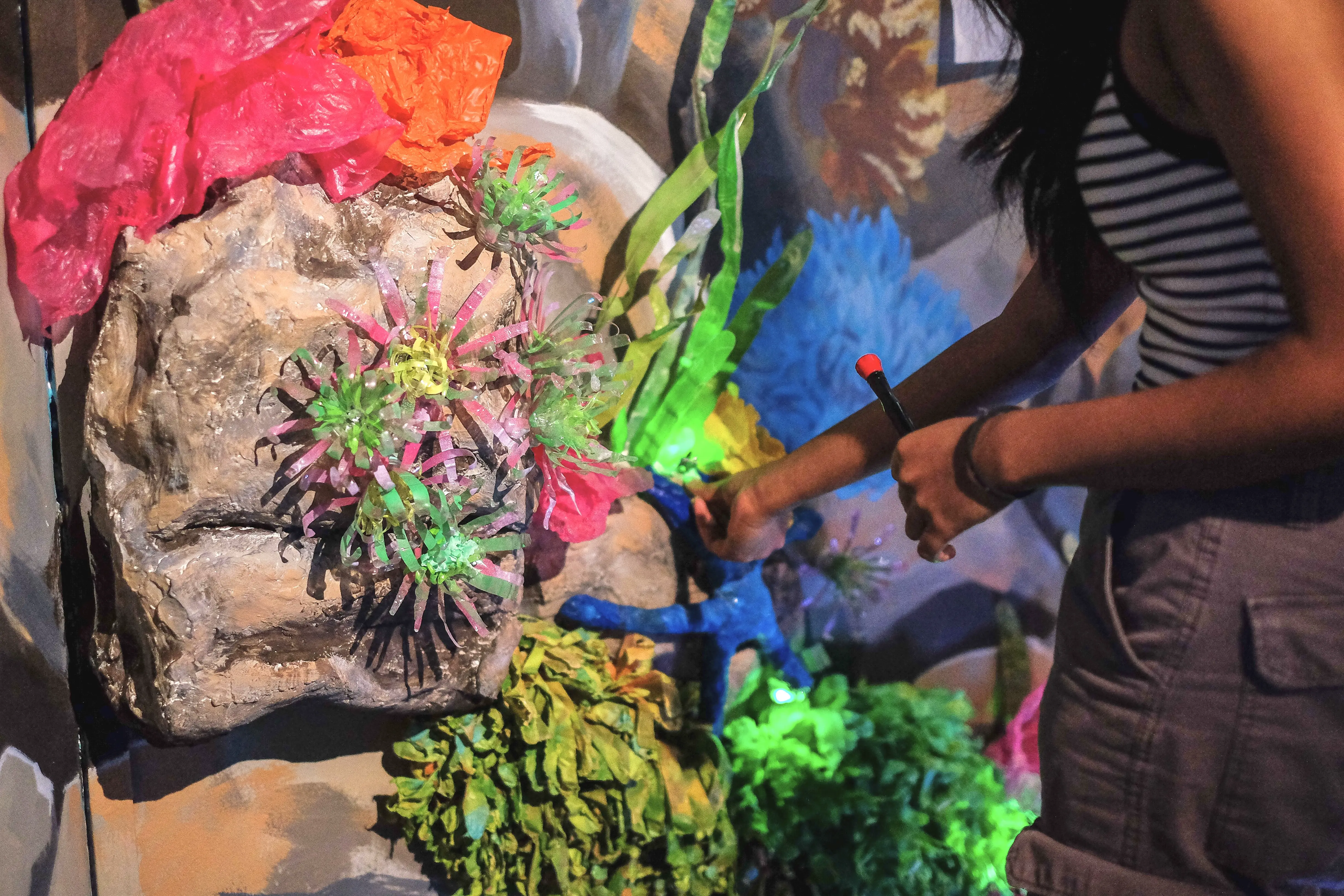 Visitors engaging with The Heart light sculpture